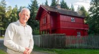 Gordon Christie is seen here next to a Swiss Cottage he restored - which sits alongside the A98 on the outskirts of Fochabers