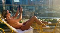 Christine McGuinness made the most of the UK heatwave as she stripped off to top up her tan on the rooftop of a London apartment