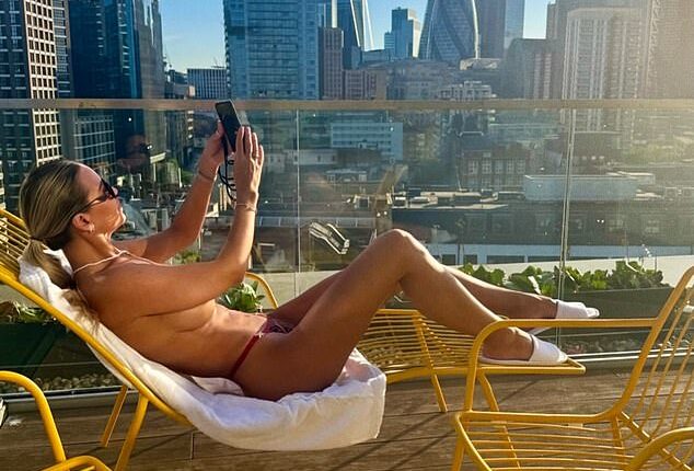 Christine McGuinness made the most of the UK heatwave as she stripped off to top up her tan on the rooftop of a London apartment
