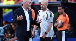 Head coach Steve Clarke consults assistant Steven Naismith during the Morocco match