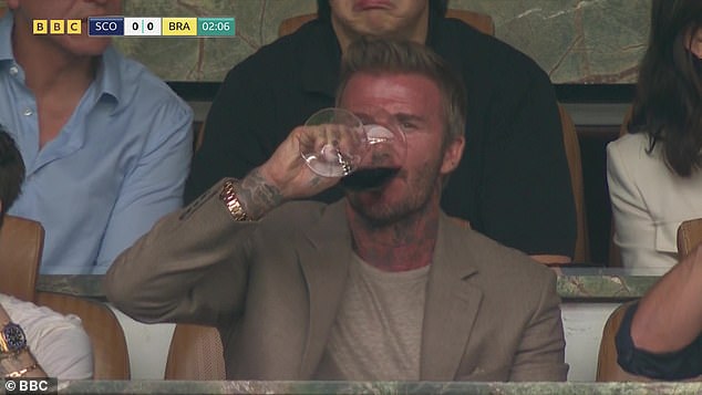 David Beckham was spotted knocking back a glass of red wine while sat in a box waiting for the Scotland vs Brazil World Cup game to begin on Wednesday night