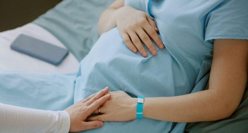 woman holding pregnant belly