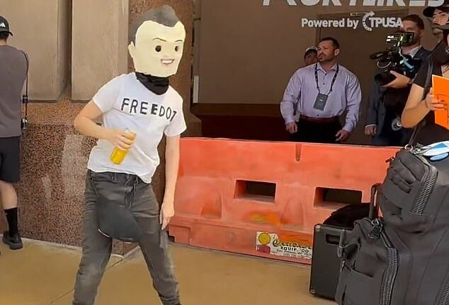 Among those rallying outside of Turning Point USA's Women's Summit in Texas, one protester was seen in a head covering made to resemble Kirk, who was assassinated last year