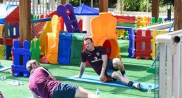 Wayne Rooney stretches out in a children's playground at the 2014 World Cup in Brazil
