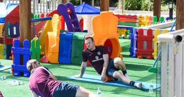 Wayne Rooney stretches out in a children's playground at the 2014 World Cup in Brazil