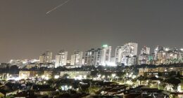 A streak of light illuminates the sky during a missile attack from Iran towards Israel today, as seen from Ashkelon