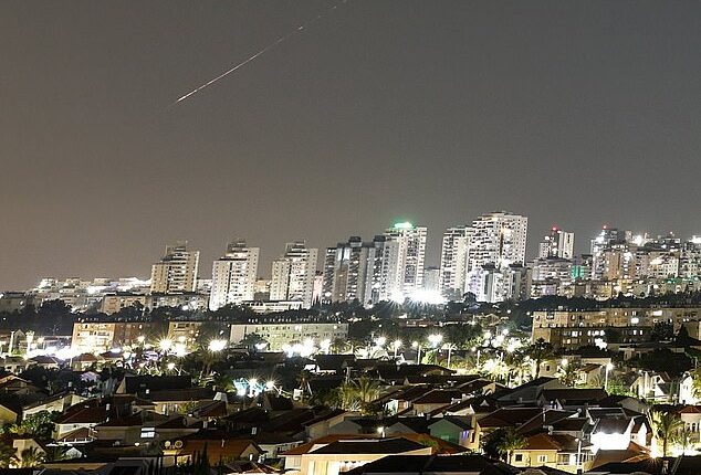 A streak of light illuminates the sky during a missile attack from Iran towards Israel today, as seen from Ashkelon