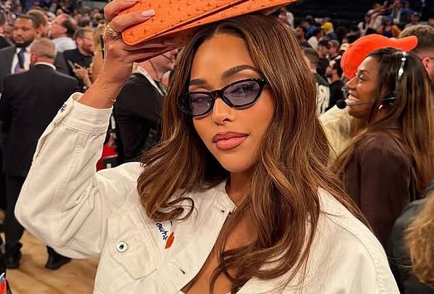 Jordyn Woods has brought her Woods by Jordyn's Tux Clutch Mini in Orange Ostrich ($125) to every winning Knicks game, leading fans to believe it's the team's lucky charm
