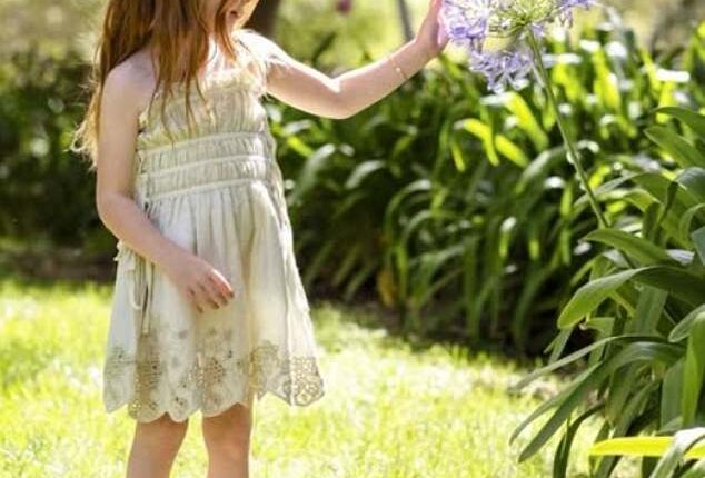 Lilibet’s side profile is shown as she inspected an agapanthus flower in the California sunshine of their Montecito mansion.