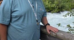 Cade Larsen poses on a recent trip. He had a brain tumor that damaged his ability to control hunger and now he weighs over 300lbs because he can't stop eating
