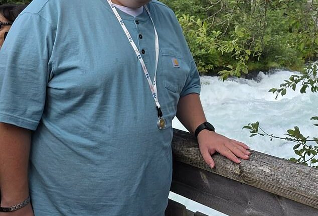 Cade Larsen poses on a recent trip. He had a brain tumor that damaged his ability to control hunger and now he weighs over 300lbs because he can't stop eating