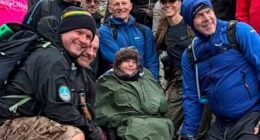 Kate (wearing baseball cap) poses for a group photo next to Ted during the Ben Nevis climb
