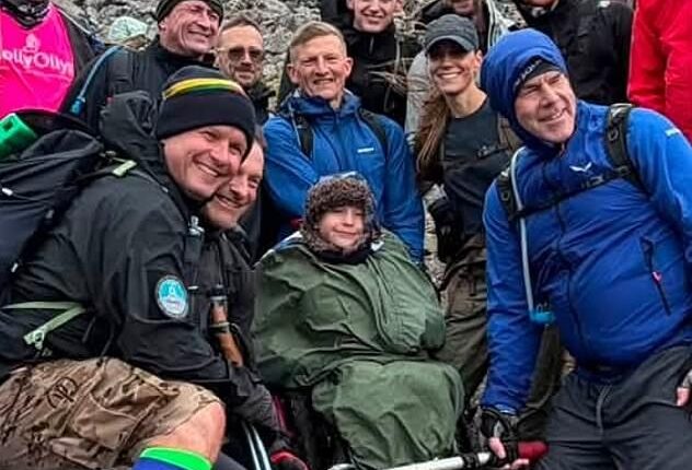 Kate (wearing baseball cap) poses for a group photo next to Ted during the Ben Nevis climb