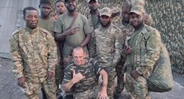 Pictured centre: Ben Stimson, 50, the Oldham antiques dealer and proud socialist who boasts of feeding desperate African fighters into Vladimir Putin's meat grinder