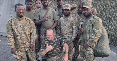 Pictured centre: Ben Stimson, 50, the Oldham antiques dealer and proud socialist who boasts of feeding desperate African fighters into Vladimir Putin's meat grinder