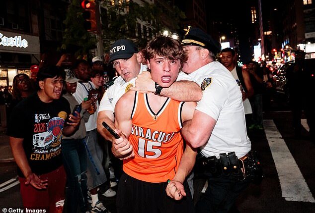 Pandemonium in New York as Knicks fans flood the streets after historic comeback - as supporters SMASH yellow cabs and light explosives while waving Palestinian flags