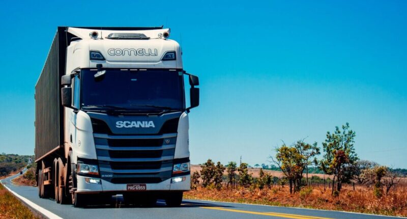 Truck driving down a road.