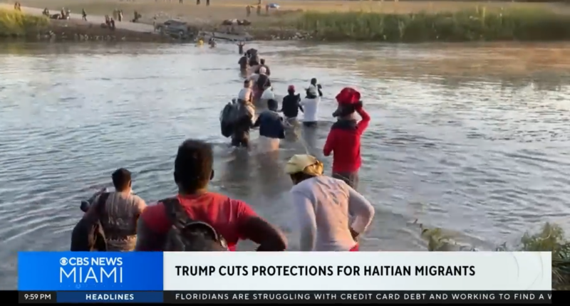Haitians crossing a river.
