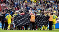 Players and staff shield Denmark's Christian Eriksen after he collapsed again mid-match