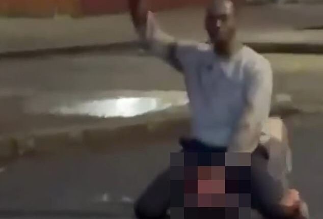 Disturbing footage appeared to show a man attempting to hack into his victim's neck before heroic bystanders, one wielding a hurling stick, hauled him off the victim
