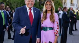 Donald and Melania Trump pose for a photo in front of the White House press photographers during the congressional picnic on the South Lawn of the White House on May 19