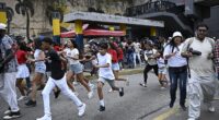 People run into a street in panic following an earthquake in Caracas on Wednesday evening