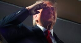 Why does Trump keep saluting during the National Anthem?