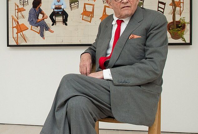 David Hockney, who died aged 88, posing in front of his artwork 'The Chairs'