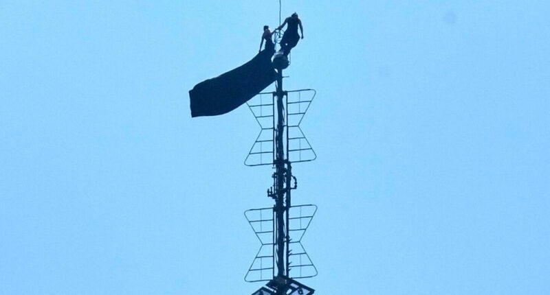 2 People Unfurl Banner Atop Iconic Building Before Getting Arrested