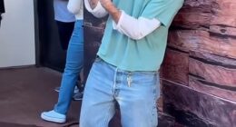 Brooklyn Beckham gave a two-finger salute as he admitted wife Nicola Peltz isn't a fan of his fashion as he sported £715 Balenciaga boots and 'caretaker' keys