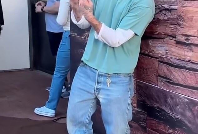 Brooklyn Beckham gave a two-finger salute as he admitted wife Nicola Peltz isn't a fan of his fashion as he sported £715 Balenciaga boots and 'caretaker' keys
