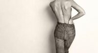 Cruz Beckham's girlfriend Jackie Apostel told fans to embrace their scars as she posed topless to mark two years since she had extensive spinal surgery