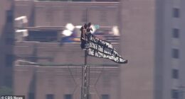 A pair of masked daredevils were spotted climbing to the very top of the Empire State Building in New York City on Wednesday
