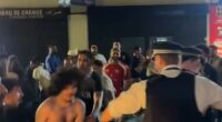 Dramatic footage from the scene captured police officers wrestling with shirtless fans as crowds spilled across the road