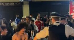 Dramatic footage from the scene captured police officers wrestling with shirtless fans as crowds spilled across the road