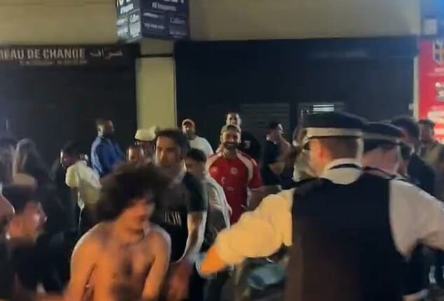 Dramatic footage from the scene captured police officers wrestling with shirtless fans as crowds spilled across the road
