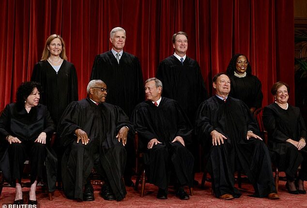 The Supreme Court justices are seen posing for a group portrait. Justices sided with the Trump administration 6-3 on two major immigration and asylum cases