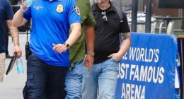In bombshell new exclusive photographs, Swift's trusted heads of security (middle and right) were pictured outside the iconic venue on Tuesday as preparations for the event ramped up