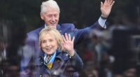 Former President Bill Clinton, behind, and former Secretary of State Hillary Clinton arrive on stage during the dedication ceremony for the Obama Presidential Center, June 18