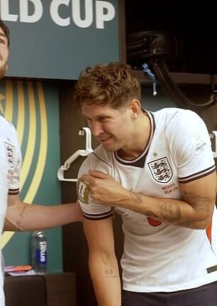 John Stones winced as he pointed to his shoulder