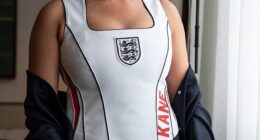 Kate Kane stunned in a white custom halter neck football shirt embossed with her husband Harry's surname in red lettering