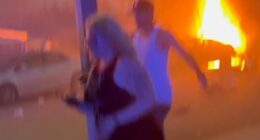 Bystanders are seen running away after a vehicle caught fire after fireworks exploded in Chino, California on Saturday night