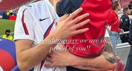 Goalkeeper Matt Turner hugs his son Easton, 4, in the stands after the game in Santa Clara