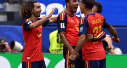 Spain's players Marc Cucurella and Rodri celebrate with goalscorer Mikel Oyarzabal