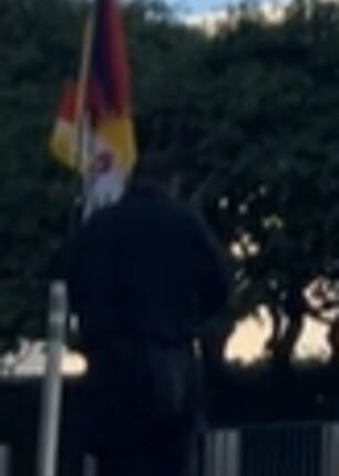 Palden Lobsang, 52, shared the video, capturing him walking to the street corner in Midtown Manhattan, carrying a Tibetan flag