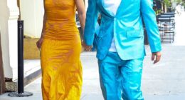 Clashing colors! Singer Ed Sheeran stood out from the crowd as he sported a bright turquoise silk suit with a paisley pattern on it. Underneath, he wore a white t-shirt, and accessorized with a pair of black Nike sneakers complete with a matching turquoise 'swoosh' on the side. His wife, Cherry Seaborn, wore a bright yellow, silky, curve-hugging gown that also appeared to have a paisley pattern on it. She paired the high-neck dress with bedazzled sky-high heels, a diamond necklace, and dangling diamond earrings