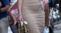 Sarah Blackburn King, 34, who is married to Travis Kelce's childhood friend Reggie King, was seen heading off for the night in a curve-hugging, gold ruched gown with one-shoulder detailing. She paired the look with a small metallic gold purse, along with strappy metallic gold heels, wearing her hair in beach waves