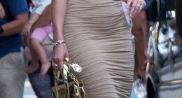 Sarah Blackburn King, 34, who is married to Travis Kelce's childhood friend Reggie King, was seen heading off for the night in a curve-hugging, gold ruched gown with one-shoulder detailing. She paired the look with a small metallic gold purse, along with strappy metallic gold heels, wearing her hair in beach waves